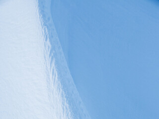 Snow texture. Wind sculpted patterns on snow surface. Wind in the tundra and in the mountains on...