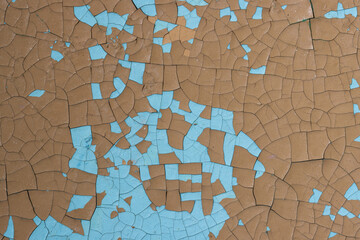 Peeling paint on the wall. Old concrete wall with cracked flaking paint. Weathered rough painted...
