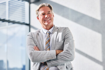 Arms crossed, smile and thinking with business man in office for corporate management or planning....