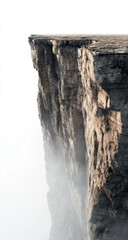 A huge cliff, with fog covering the top of it. The edge is a flat rock surface, and there's an empty space on one side. It features a white background