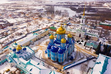 Aerial panoramic view of architectural complex of Nativity of Mother of God Monastery in small Russian town of Zadonsk on winter day..