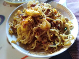 Delicious spicy noodles with egg, potato,  green chilli,  spices,  and tomato sauce. Noodles ingredients good for health. Noodles snacks as breakfast. 