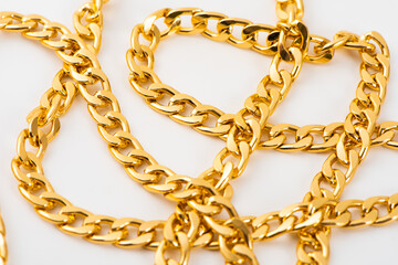 Obraz premium closeup of gold jewelry chains set on white background. 