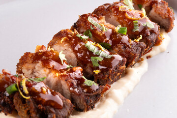 close up of pork pancetta strips under parmesan cream