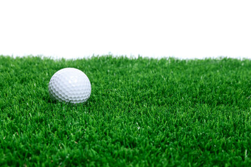 Golf ball on green grass against white background