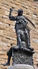 The statue of Judith and Holofernes by Donatello, a bronze sculpture depicting Judith raising a sword to behead the Assyrian general Holofernes, located in Piazza della Signoria, Florence.