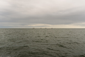 The ocean is calm and the sky is cloudy