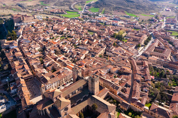 Fototapeta premium Picturesque aerial view of Siguenza townscape with residential areas, medieval Roman Catholic Catedral de Santa Maria and ancient reconstructed castle on spring day, Spain