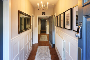 Hotel, building and corridor or accommodation hospitality service or travel vacation in apartment, lodge or holiday. Door, hallway and interior design or decor as architecture, property or staycation