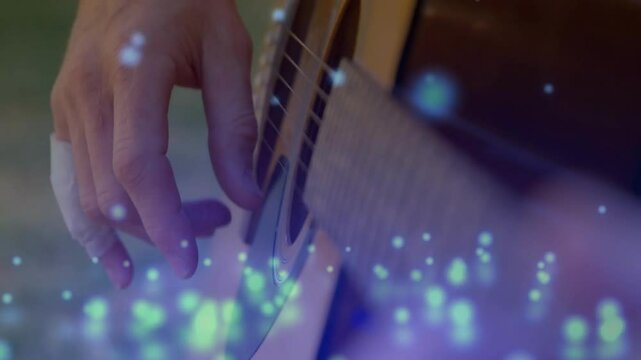 Guitar player pressing steel strings on fretboard in music studio, with floating blue light
