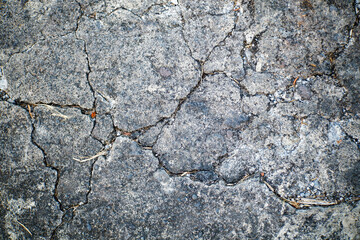 Damaged road with lots of cracks. Abstract background of damaged road