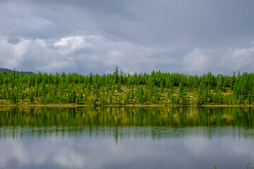 Obraz premium Sunset panorama of small lake with mountain reflection in Siberia, Buryatia, Russia