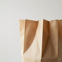 Close-up image of a crumpled brown paper bag against a soft light background, highlighting its natural texture and eco-friendly appeal, perfect for themes of sustainability and simple living