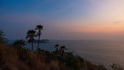 Viewpoint of Promthep cape with colorful sky and palm tree at sunset time, Island Phuket