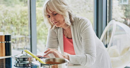 Cooking, woman and phone in kitchen with recipe, online text and food planning in a home. Stove,...