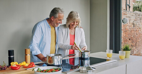 Mature, couple and cooking in home with support, love and meal prep with healthy food in kitchen. Happy, man and woman embrace together at stove with vegetables, diet or nutrition in dinner or lunch