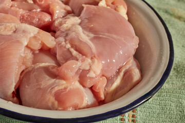 A bowl of raw, skinless, boneless chicken thigh meat