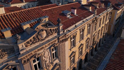 Warm sunlight illuminating ornate facade of historic warsaw presidential palace, revealing intricate architectural details and rich tiled roof textures in elegant neoclassical style