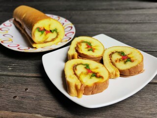 Bolu Gulung or Bolu Rolls in White Plate on Wooden Floor.