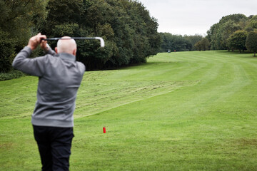 Golf, man and swing on grass for game, sports club and playing for weekend hobby in retirement....