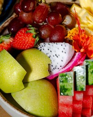 Fruit salad delight colorful seasonal fruits in a bowl vibrant kitchen setting close-up view healthy eating concept