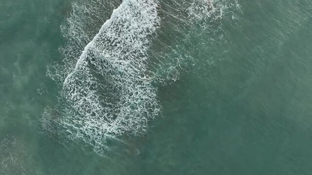 Aerial view of a sandbar and coastal shoreline along Taiwan&rsquo;s northeast coast, with waves surrounding the sand formation.