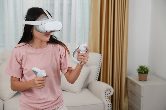 A woman plays virtual reality in her living room, playing boxing games, exercising.