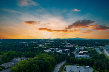 Aerial shot of office buildings, apartments and lush green trees in the city skyline in Atlanta...