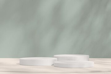 Three white podiums on a sandy background with soft natural shadows, ideal for showcasing product.