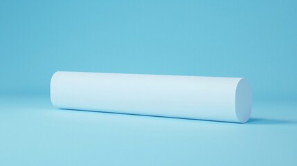 A simple, cylindrical object rests on a light blue surface, showcasing a minimalist design and soft lighting.