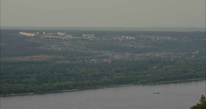 Barge navigating Volga river near Samara, Russia during hazy day