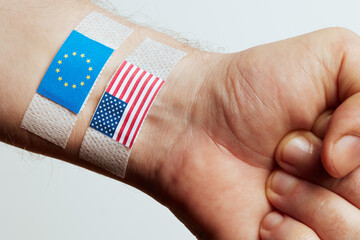 Wrist with EU and US Flags Representing Economic Conflict