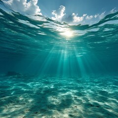 Naklejka premium Serene Underwater Scene Showcasing Sunlight Shimmering Through Crystal Clear Ocean Water, Highlighting Tranquil Marine Environment and Beautiful Sand Bed