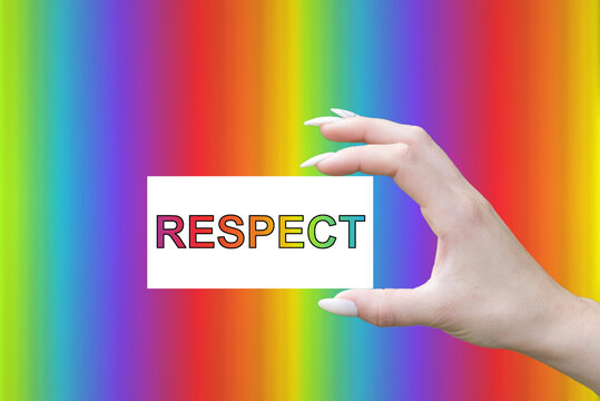 A hand holds a note of respect on a rainbow-colored background