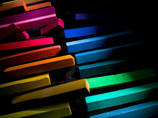 colorful chalk pastels on black background