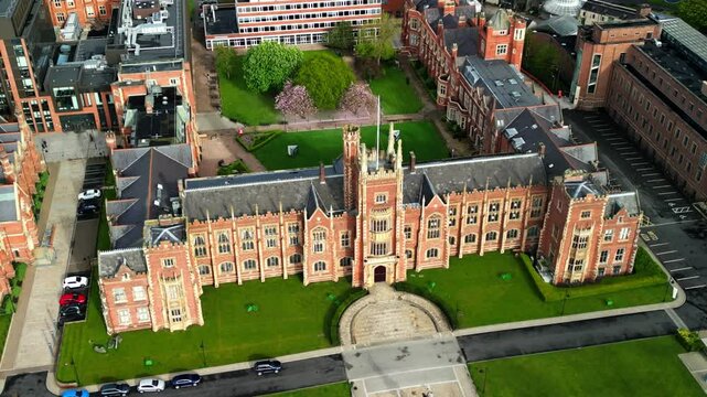 Descending, rotating aerial video of Queen's University, Belfast and the surrounding area in Northern Ireland, UK. Filmed on a bright, sunny day in 4K, 30FPS and with Rec709 Color.