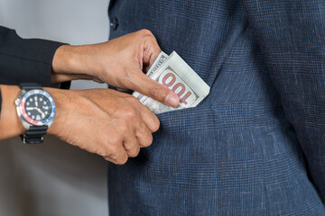 Businessman refusing to take bribe. Corruption concept. Detail of two business people sealing