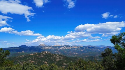 Expansive mountain vista under a vast azure sky.