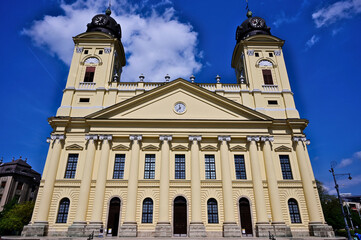 the Reformed Great Church exterior elevation in Debrecen. yellow stucco finish. perspective view. icon of Protestantism in Hungary. a National Monument a Classicist style famous landmark in downtown.
