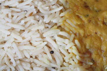 Simple rice served alongside flavorful lentil curry dish
