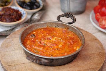 Delicious turkish menemen served in a traditional pan at a cozy cafe