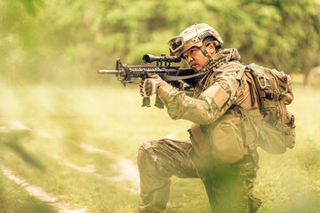 The jungle’s stillness is deceptive, but the soldier is alert, trained to notice even the...