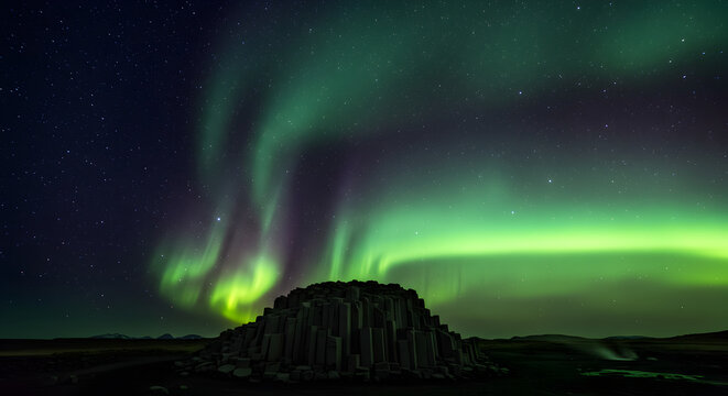 Aurora Borealis Dazzles Above Basalt Columns in Magical Icelandic Landscape - Powered by Adobe