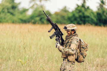 Soldiers survey their surroundings, breathing evenly while taking precise aim, demonstrating the...