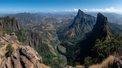 Naklejka premium A mountain range with a river running through the valley.