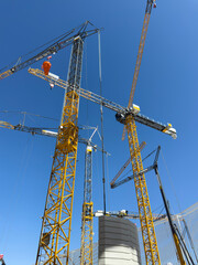 Construction cranes. View from below. Crane used to construct palaces, houses or buildings. Construction site. General contest