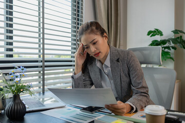 a female employee is feeling very stressed and tired form work, a businesswoman shows signs of...