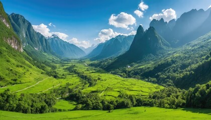 Fototapeta premium Green grass and rocky peaks define the panoramic mountain landscape of the Alps under a summer sky
