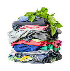 Stack of colorful clothes with fresh green leaves on top, cut out - stock png.