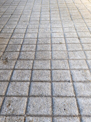 A close up of a sidewalk made of concrete blocks